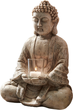 Dekorativ Buddha med ljuslykta