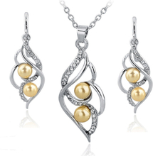 Smyckeset med Austrian Crystals och Simulated Pearls - 925 Sterling Silverplätering och gula Pärlor