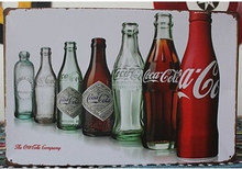 Emaljeskilt Coca Cola-flasker gennem tiderne